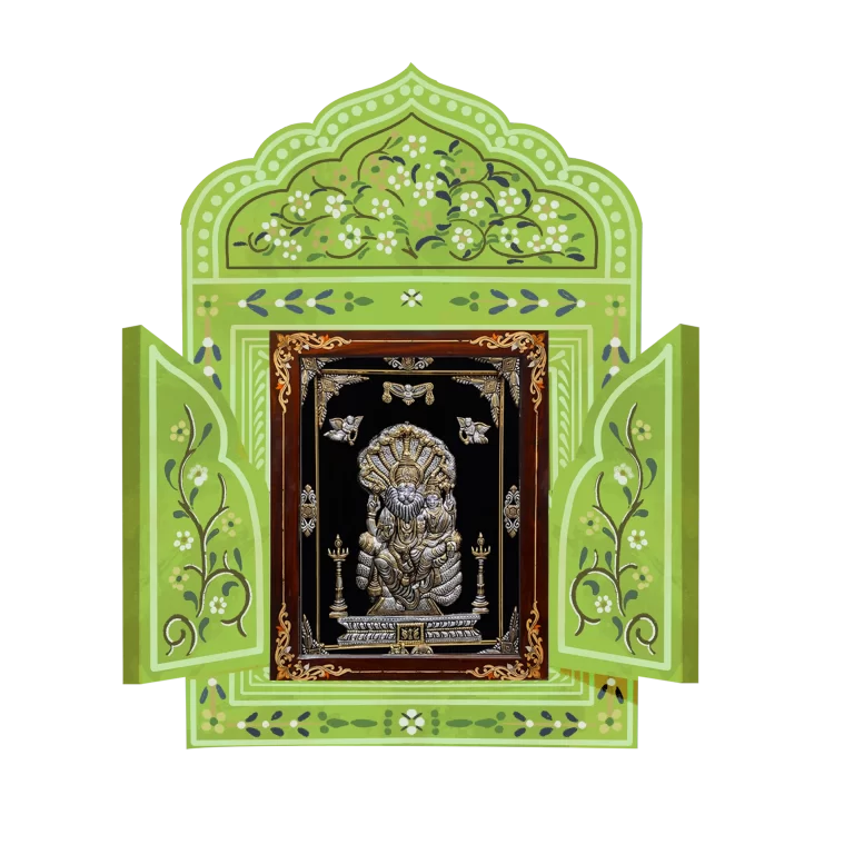 An antique designed green and silver Indian God Lord Ganesha seated within an open ornamental frame.